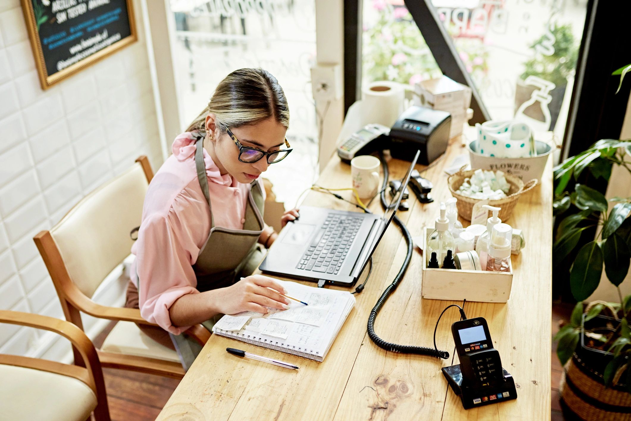 Small business owner doing accounting on a laptop